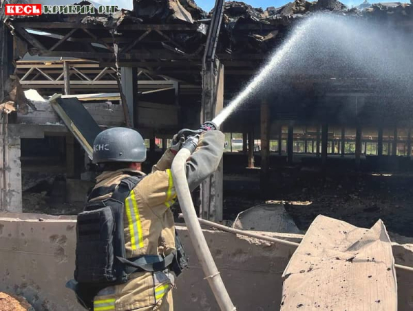 Рятувальник гасить пожежу в цеху після ракетного удару по Кривому Рогу